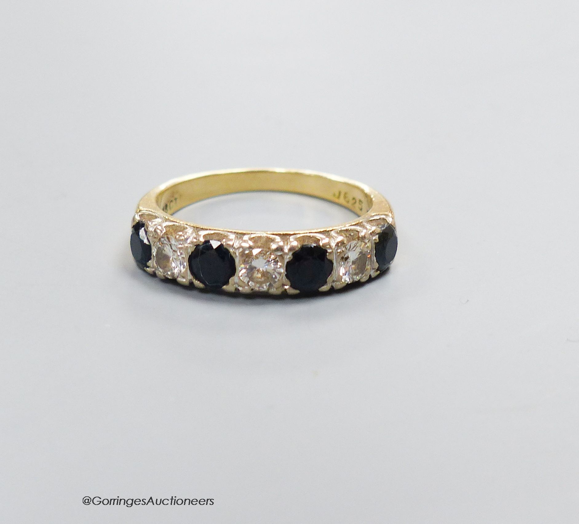 An 18ct gold sapphire and diamond seven stone ring, size N, gross 4g.